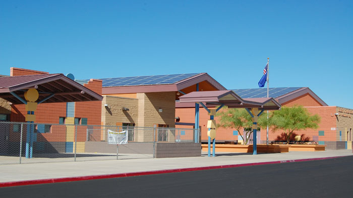 Solar panel array in Atacama Desert with blue sky and mountains in background